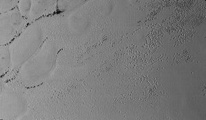 Pluto’s Puzzling Patterns and Pits